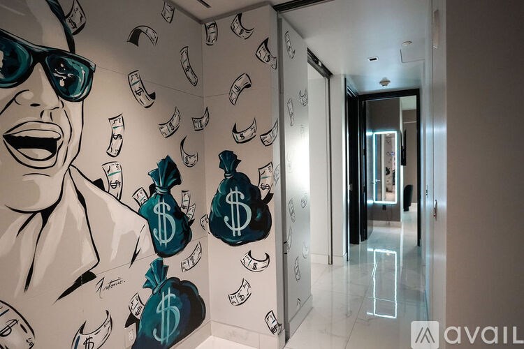 A hallway with a mural of a laughing woman and money bags on the wall.