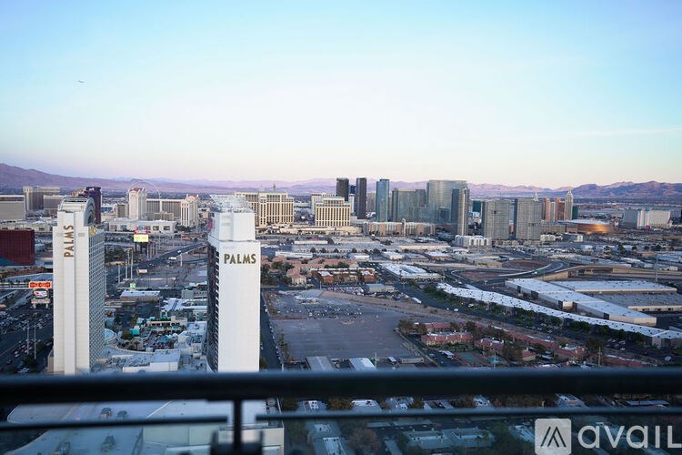 A view of a cityscape with the word "PALMS" prominently displayed on a building.