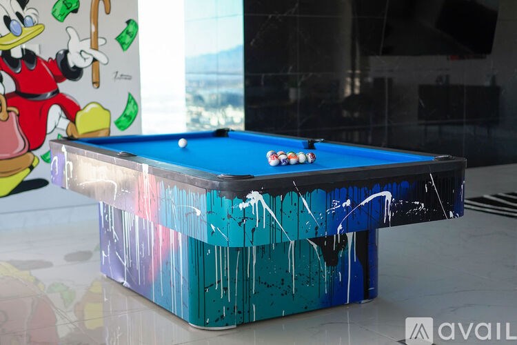 A pool table with a blue cloth and a white cue ball.