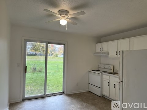 A kitchen with white cabinets and appliances is available for rent.