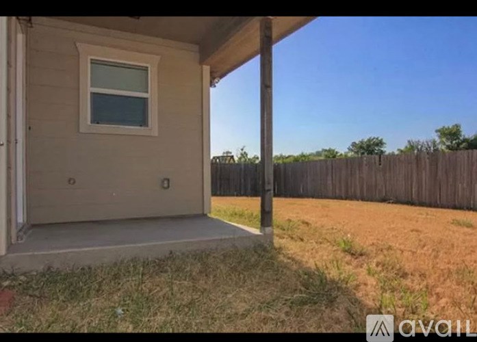 A house with a brown fence in the backyard.