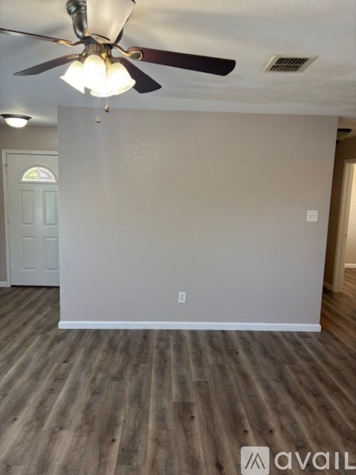 A bathroom with a white door and a white shelf above it.