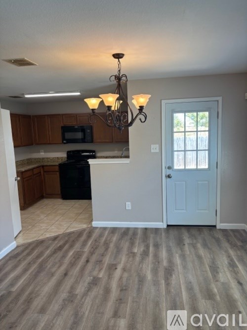 A bathroom with a double sink vanity and a mirror above it.