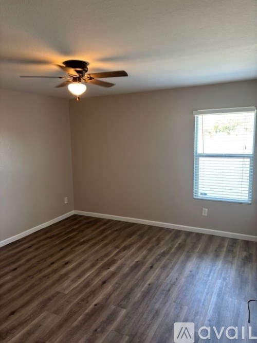 A bathroom with granite countertops and a large mirror above the sink.