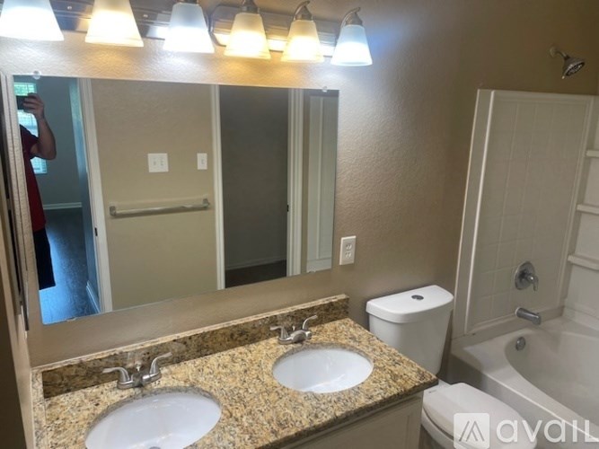 A bathroom with two sinks and a toilet.