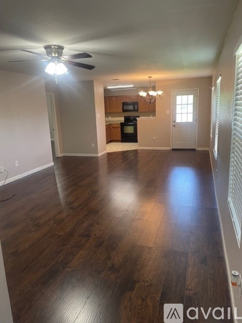 A room with wooden floors and a ceiling fan.