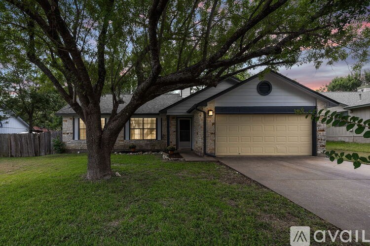 A house with a tree in front of it.