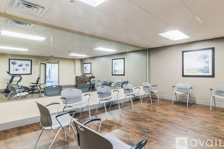 A waiting room with chairs and a mirror.