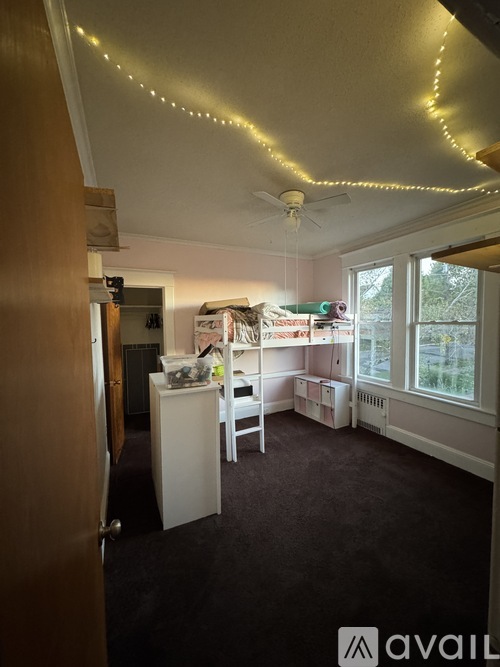 A room with a bed, desk, and chair.