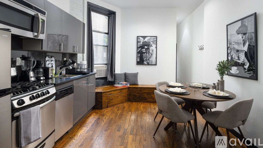A modern kitchen with a dining table set for two.