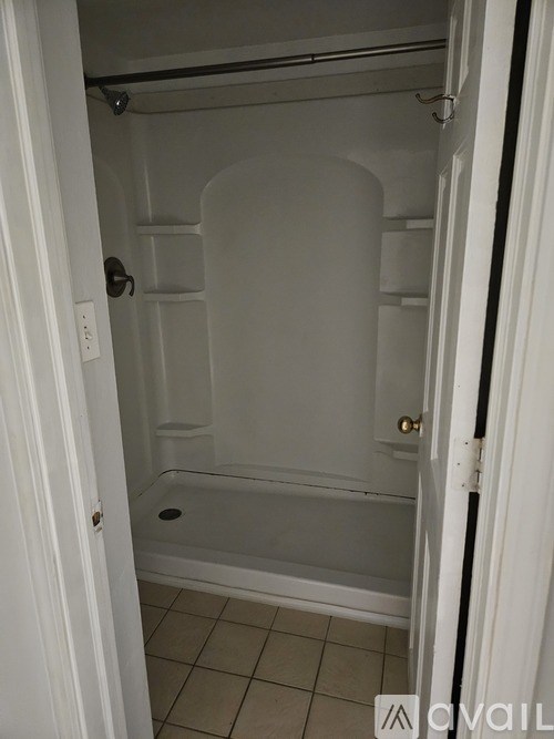 A small white bathroom with a walk in shower.