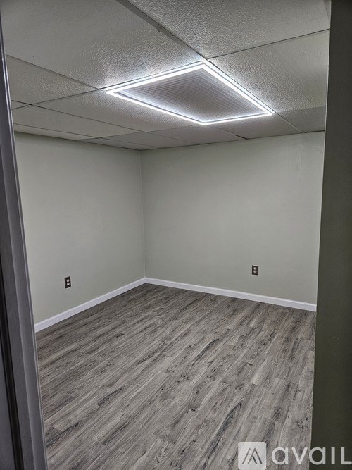 A room with a grey floor and white walls.