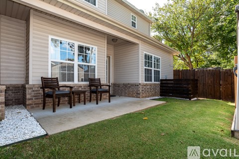 A house with a patio and a table and chairs.