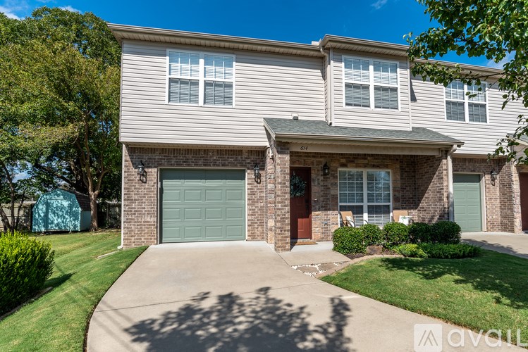 A two-story house with a garage and a driveway.