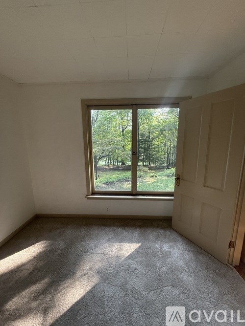 A room with a window and a door.