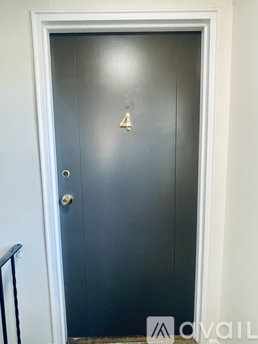 A black door with a gold number 2 on it.