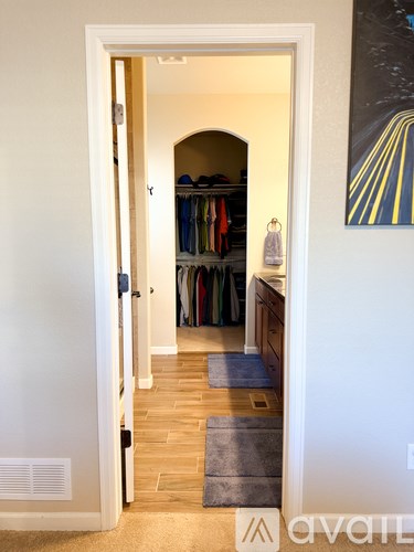 A hallway with a doorway leading to a closet.