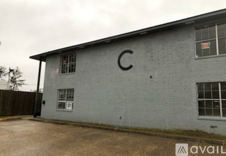 A grey building with a large letter C on the side.