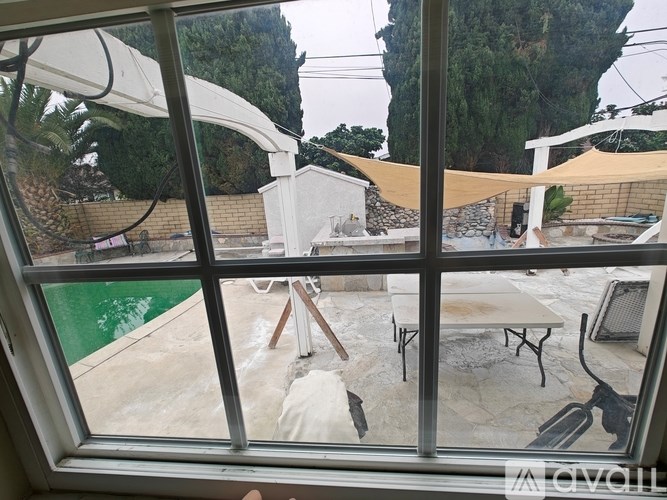 A patio with a table and chairs is visible through a window.