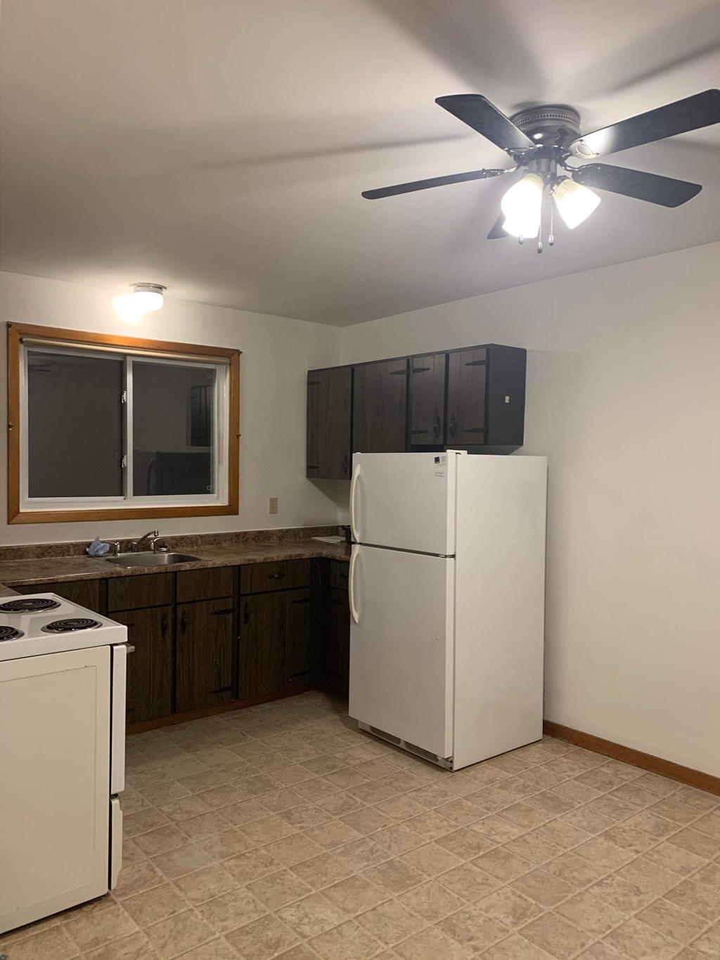 A kitchen with a white refrigerator, a white dishwasher, and a white oven.
