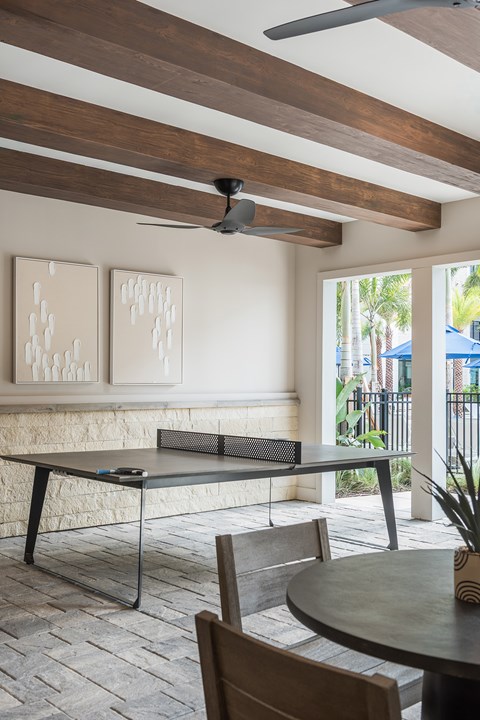 A dining room with a table and chairs.