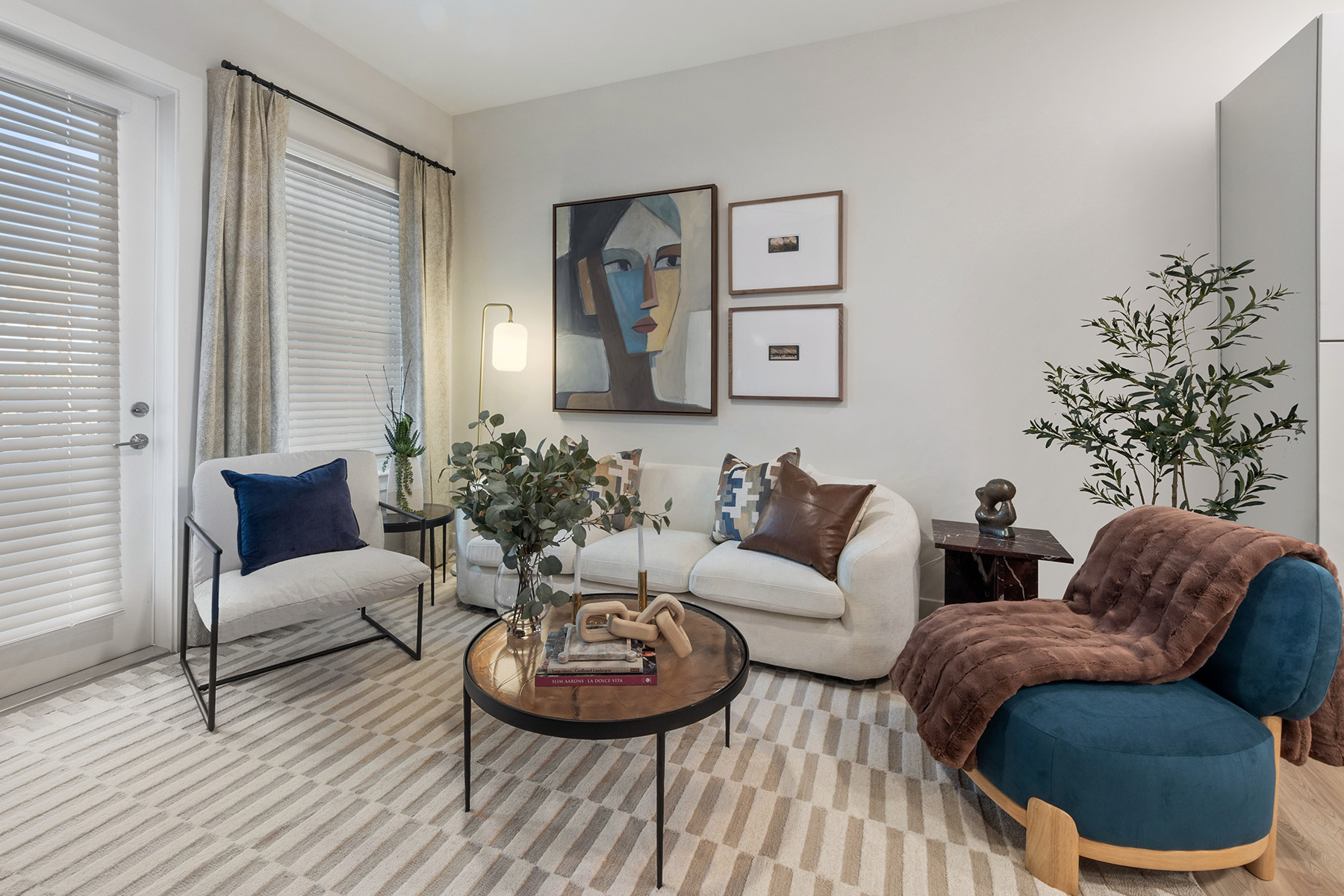 A living room with a striped carpet and a blue chair.