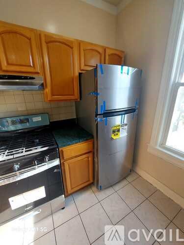 A kitchen with a stove, oven, and refrigerator.