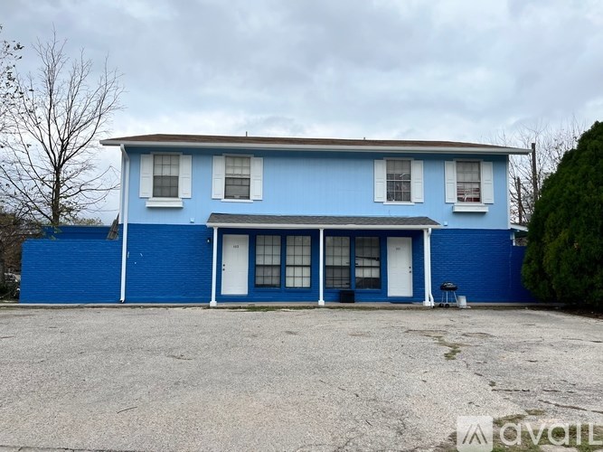 A blue house with a white door and windows.