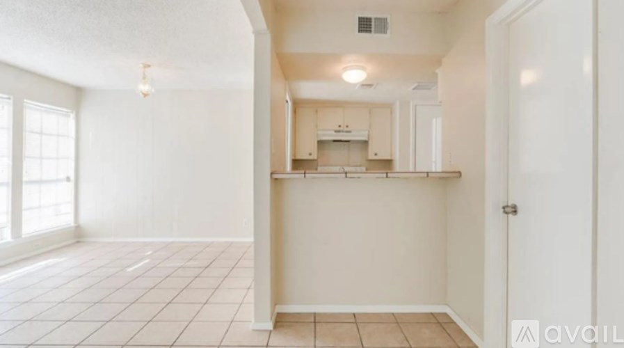 A kitchen area with a counter and cabinets is available for rent.