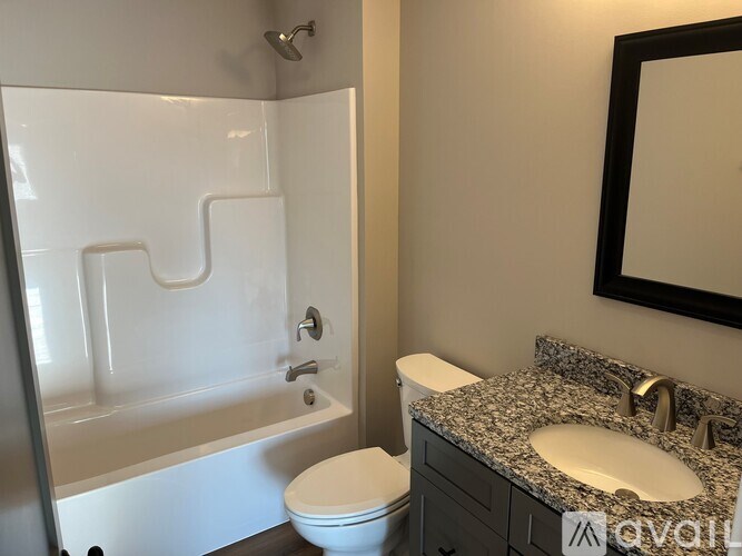 A white toilet sits next to a sink in a bathroom.