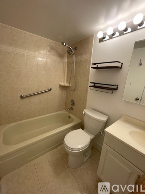A bathroom with a toilet, sink, and bathtub.