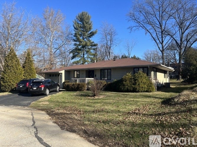 A house with a car parked in front of it.