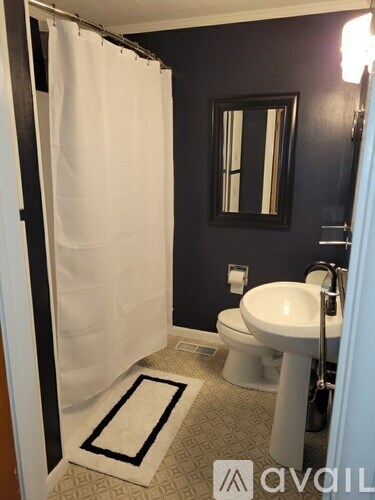 A bathroom with a white toilet and sink.