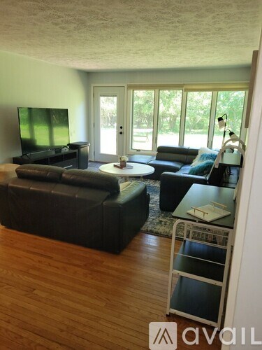 A living room with a television and a couch.