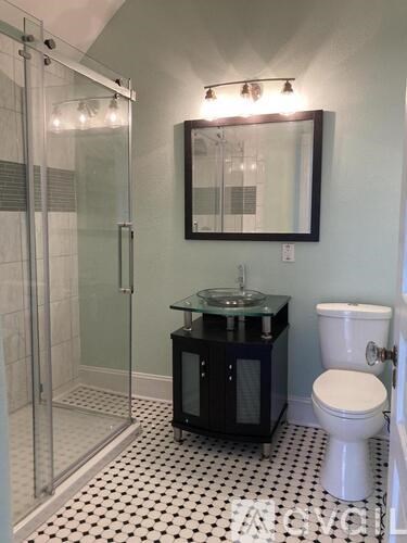 A bathroom with a toilet, sink, and shower.