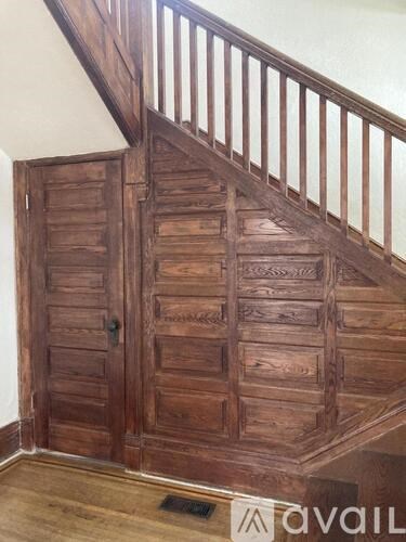 A wooden staircase with a metal railing.