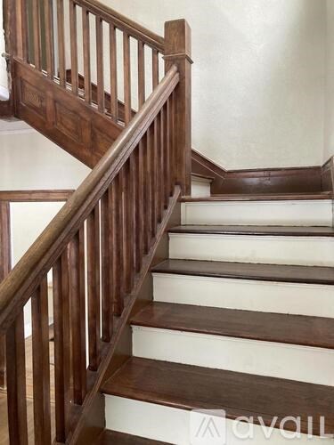 A wooden staircase with white risers.