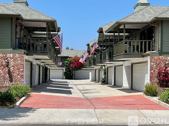 A row of houses with American flags hanging from the balconies.
