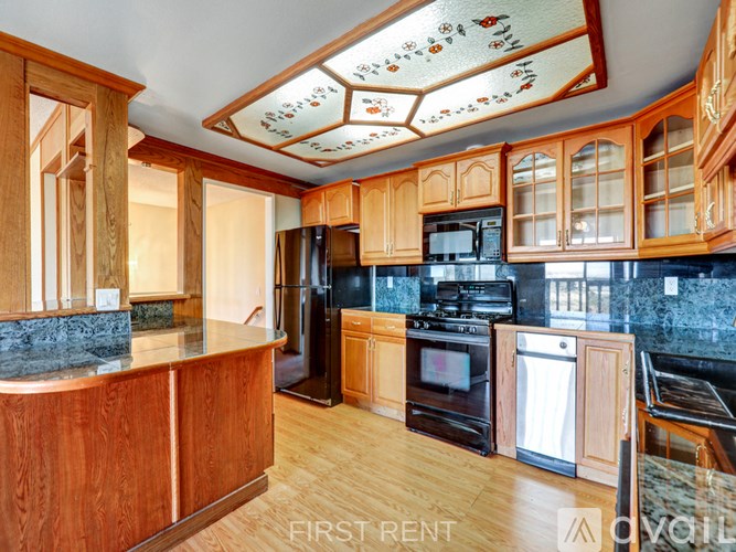 A room with a carpeted floor and a wall-mounted air conditioning unit.