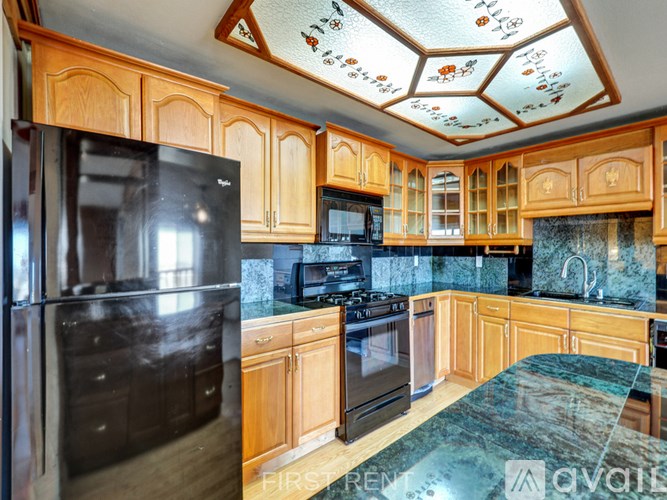 A bathroom with a toilet, sink, and mirror.