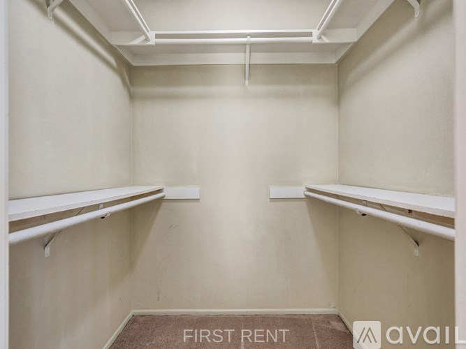 A room with a carpeted floor and a toilet visible through an open door.