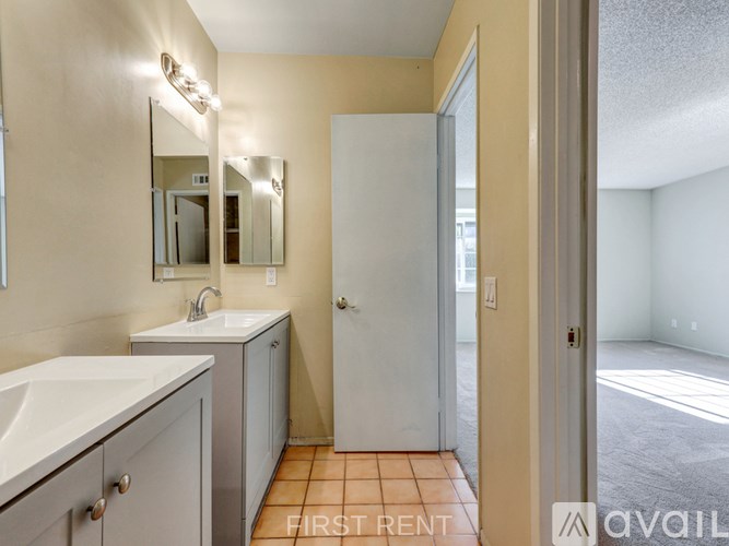 A room with a carpeted floor and a sliding glass door leading outside.
