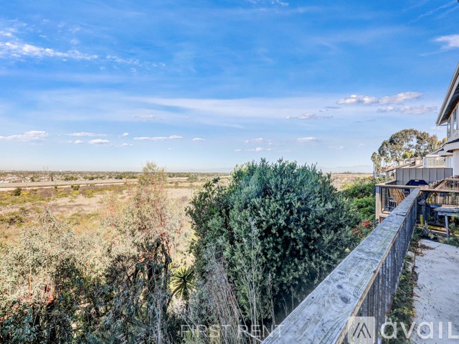 A view from a balcony overlooking a natural landscape.