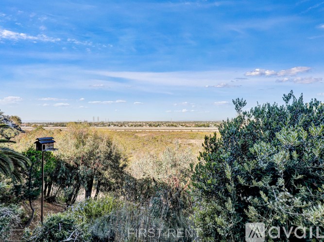 A landscape view with a clear blue sky and scattered clouds.