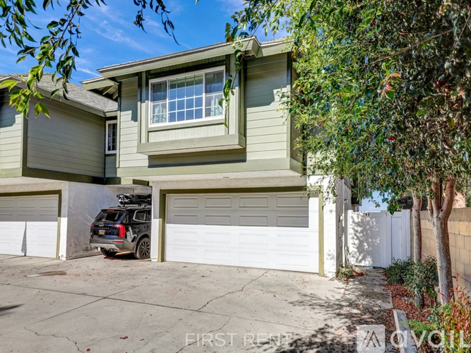 A car crashed into a garage door of a house.