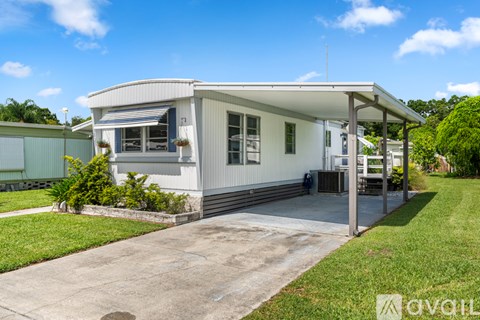 A white house with a covered patio area.