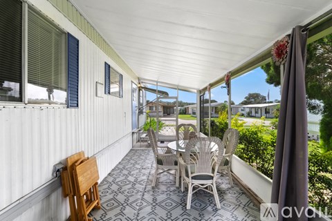 A patio with chairs and a table is shown.