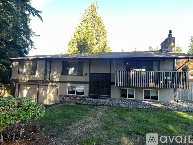 A house with a grey roof and a black door.