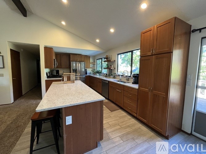 A kitchen with brown cabinets and a white countertop.