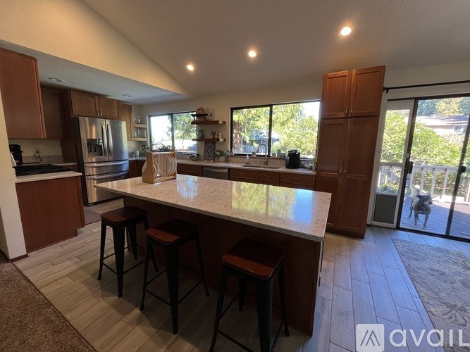 A kitchen with a bar area and a refrigerator.